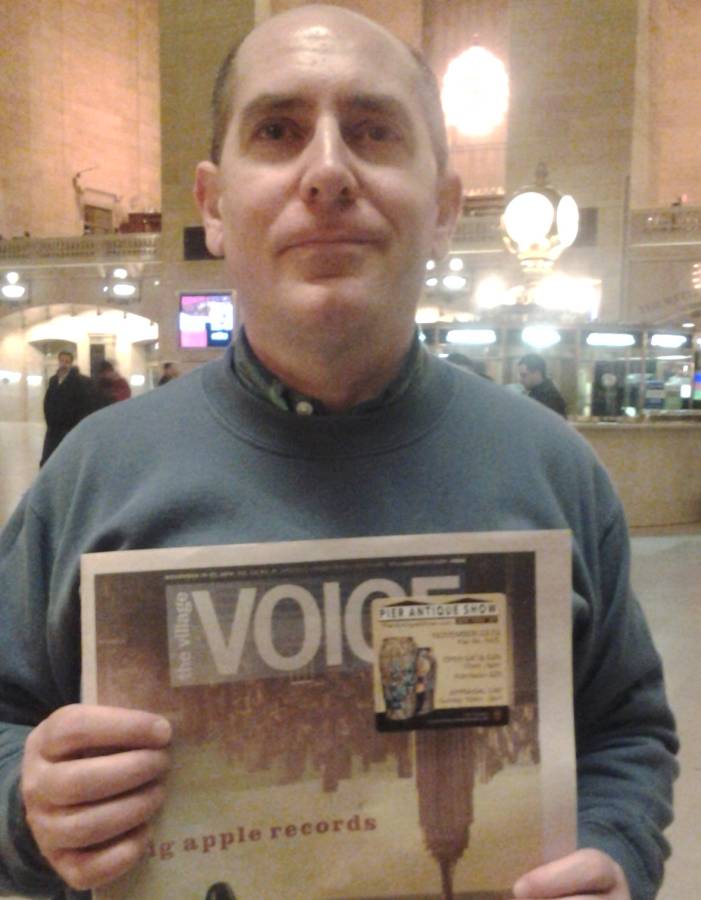 [Paul Katrich holding Village Voice with his pottery on cover]